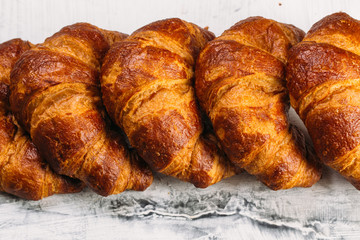Fresh baked croissants on white background