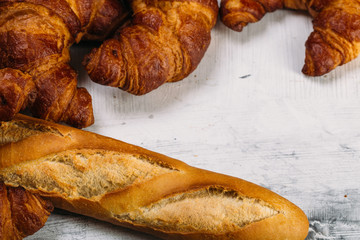 Food background with fresh baked pastry french baguette and croissants
