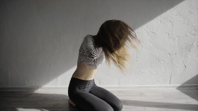Beautiful, modern teenage girl dancer dancing contemp in the studio slow motion HD