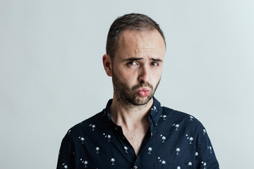 Young amusing male in studio
