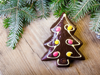 Gingerbread cookie in the shape of Christmas trees on wooden background, copy space