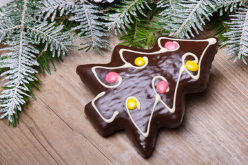 Gingerbread cookie in the shape of Christmas trees on wooden background, copy space
