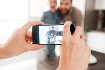 Father in the kitchen with his birthday son making selfie