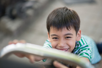 Close up of Little cute  boy playing slider at playground
