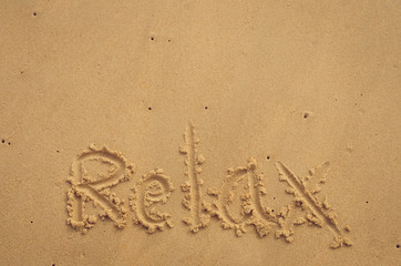 Copy space of Relax words on sand beach texture background.