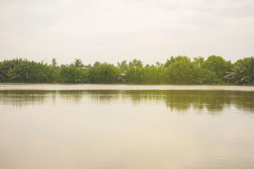 Landscape of river/lake and forest with blue sky background in Thailand