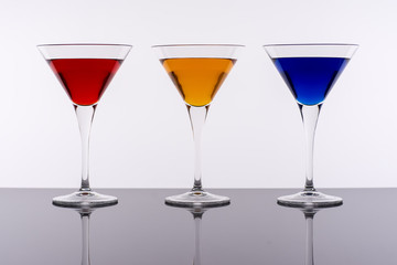 Colorful Cocktails in Martini Glasses Background. Bar Commercials Concept.