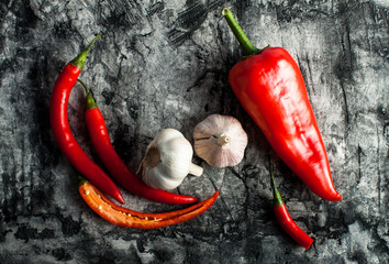 Garlic and chili on scratched background 