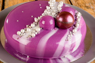 purple mousse cake with mirror glaze blackberries