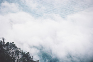 Clouds Foggy Mountains cliff and sea Landscape minimalistic style Travel serene scenic aerial view moody weather