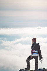Woman standing on cliff alone thinking sky clouds landscape on background Travel Lifestyle concept adventure vacations outdoor