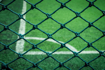 Net in front of artificial turf of Soccer football field.