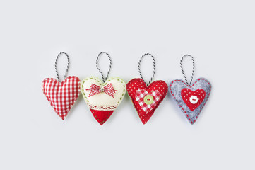 Hand made textile hearts.  Textile handicraft on a white background. Valentines Day, Wedding composition with hearts.