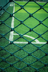 Fototapeta premium Net in front of artificial turf of Soccer football field.