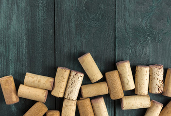 Wine corks on dark wooden texture with copyspace