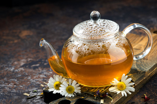 chamomile tea in a glass teapot