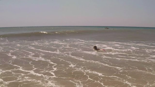 Child, Little Girl Swimming in Sea Water, young Lady plays in surf, beach