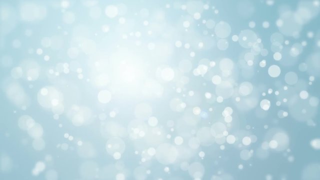 Beautiful soft silver blue background with moving light particles creating a bokeh effect.