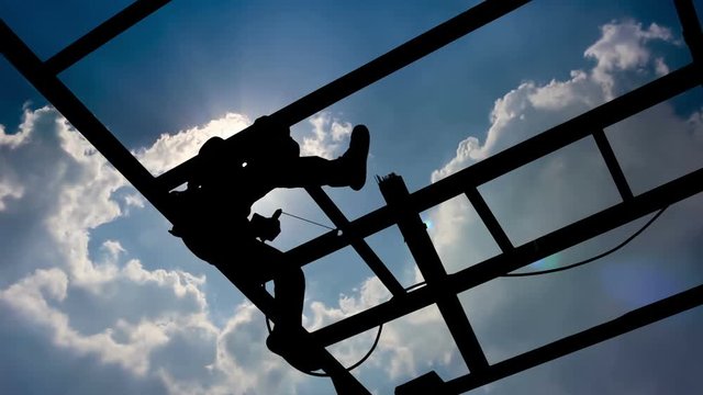 silhouette worker Welding steel on could moving