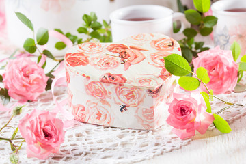 Valentine day background - tea, pink roses, gift box