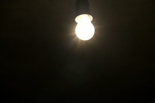 Electric light bulb on dark backround