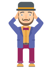 Circus actor clutching his head.