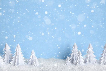 Winter Christmas minimalist background with white paper trees on blue  drawing snowflakes