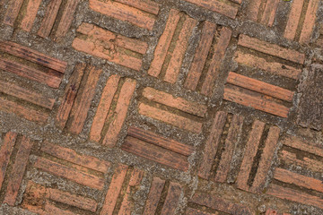 Historical old brick floor with moss and dust attached by its life time.