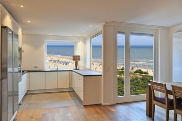 Kitchen in renovated house with view on beach at summer