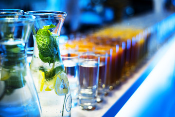 Carafe with Fresh Drink, Glass with Juice on Bar in the Background