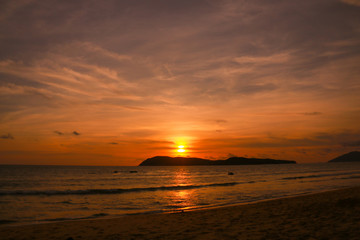 silhouette of parachute and people at the beach