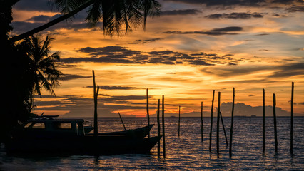 Sunset on Kri Island. Some Boats in Foreground. Raja Ampat, Indonesia, West Papua