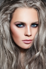 Close-up portrait of young beautiful woman with long grey hair and stylish smoky eyes make-up