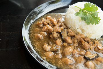 chicken with sauce over rice.
