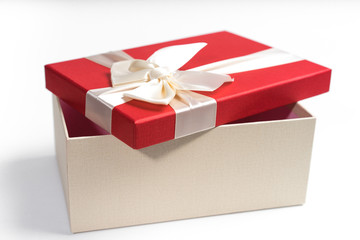 Red gift box with white ribbon isolated on white background. 