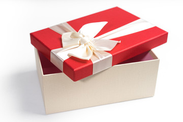 Red gift box with white ribbon isolated on white background. 