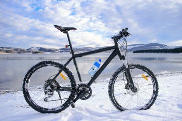 Mountain bike on lake. Winter