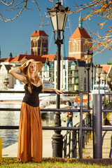 Woman wearing big sun hat and elegant dress