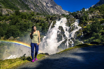 Young woman relaxing and enjoying the view on the fjord of Norwa