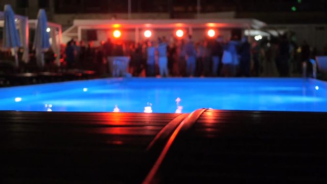 Lights Turning in the Night Club near Pool when People Dance Blurred