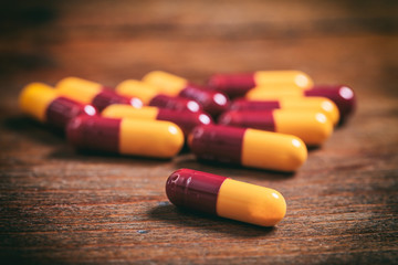 Colorful capsules on a wooden background