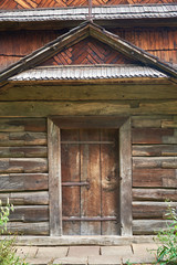 The facade of a wooden building with a door