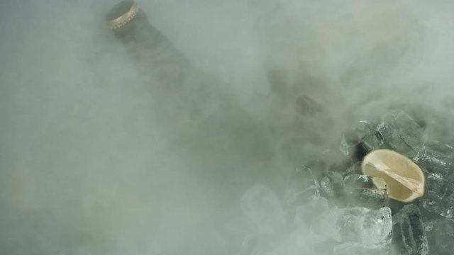 4k Shot of Cold Ice Cubes with Beer and Fog Blowed away