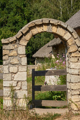 The arch of limestone and wooden gate