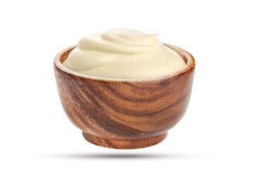 Homemade mayonnaise sauce in wooden bowl isolated on white background with clipping path