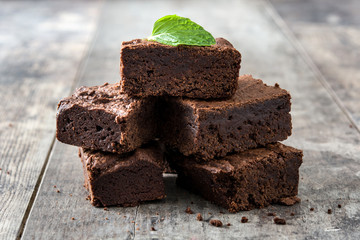 Chocolate brownie portions on wooden background
