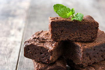 Chocolate brownie portions on wooden background

