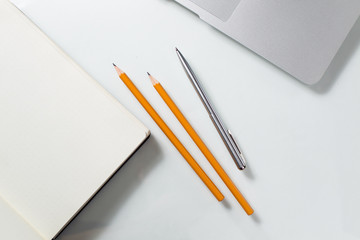 Desktop with laptop, note and stationery.