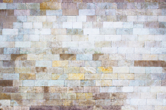 Gray wall of marble blocks, stone light texture as background
