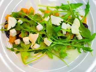 Fresh diet salad with arugula, pumpkin and beets. Delicious and